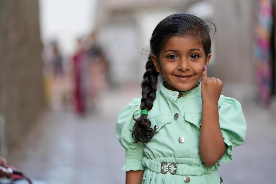 In February 2024, a young girl shows her finger, marked to indicate she has received a polio vaccination near her home in Aden, Yemen, as part of a critical polio campaign, launched with support from UNICEF.